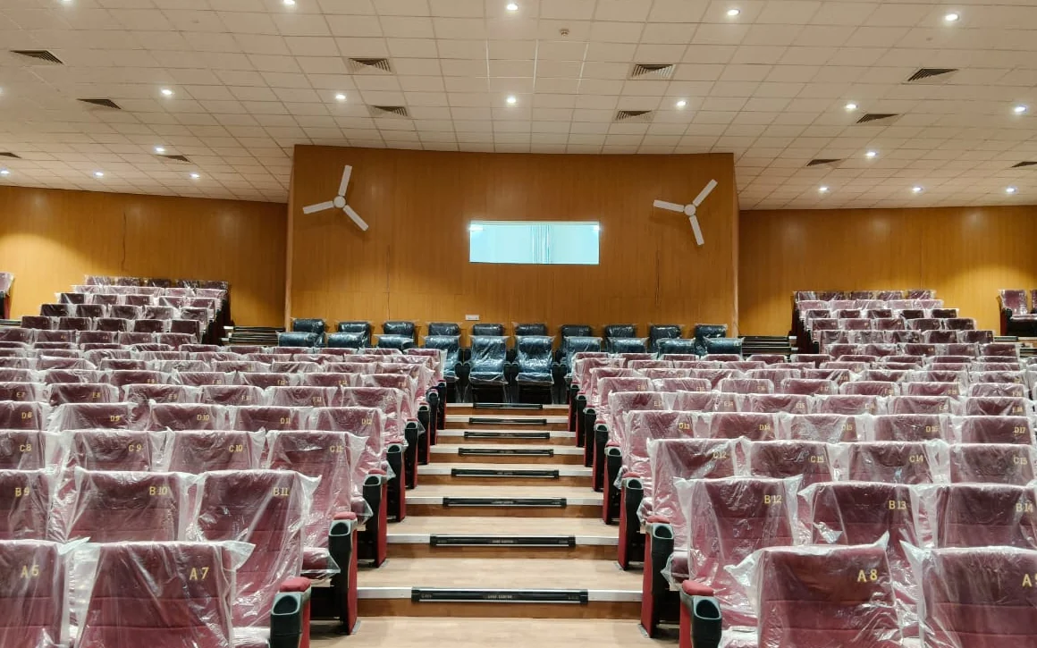 Centered view of auditorium seating, wall finishes and ceiling